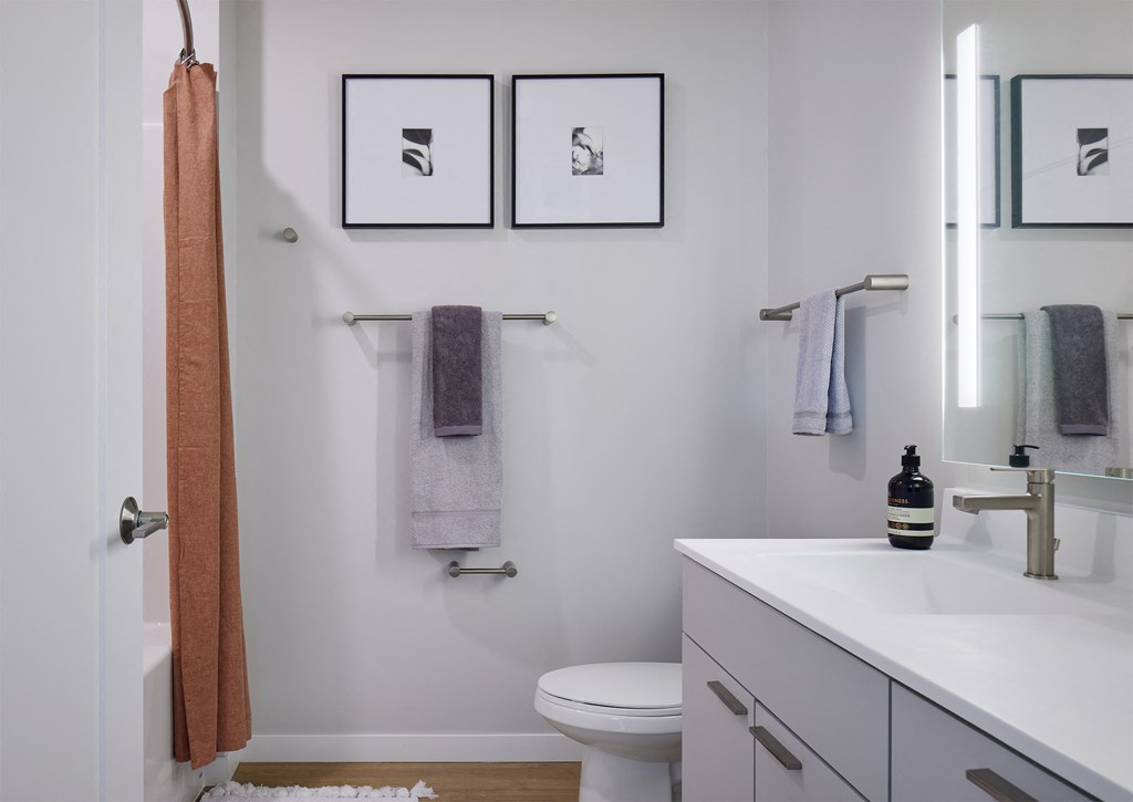 a small bathroom with a toilet and a sink and a shower