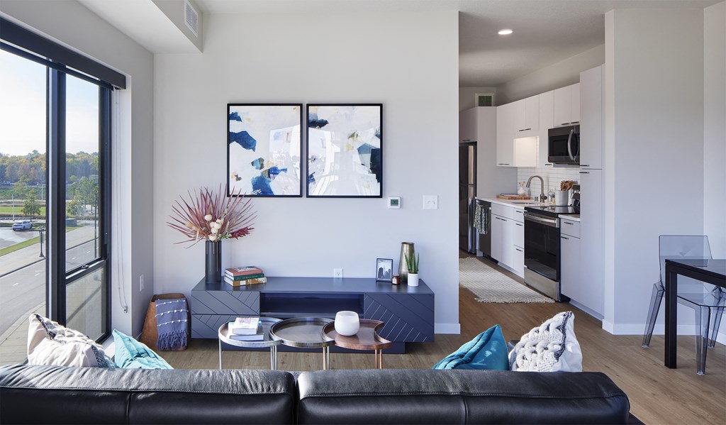 a living room and kitchen with a couch and a table