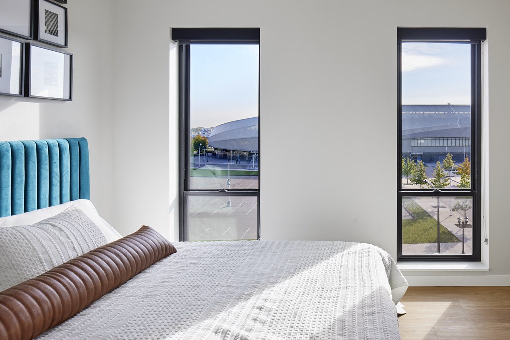 a bedroom with a bed and a view of a swimming pool