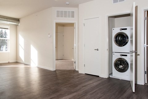 a living room with a washing machine and a dryer