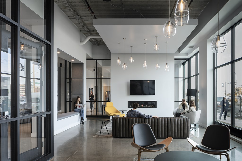 a living room with a group of people sitting around a couch and a tv