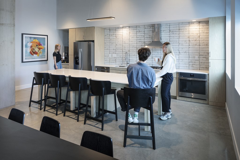 a man and a woman standing at a counter in a kitchen