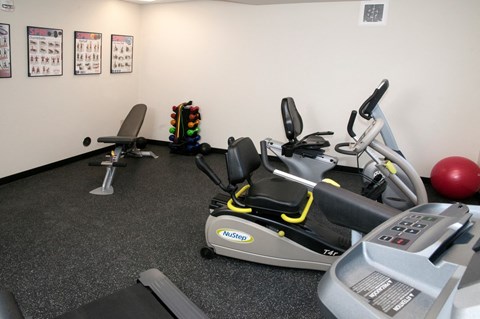 a gym with a treadmill and other exercise equipment