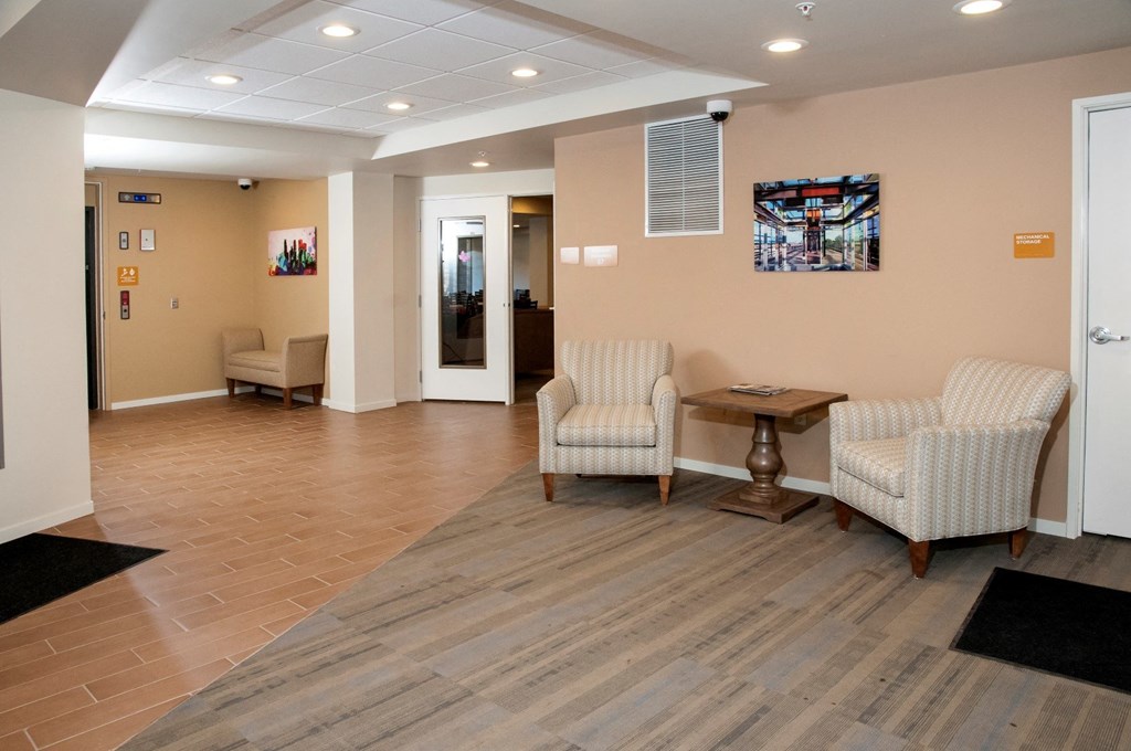 a room with two chairs and a table in a lobby