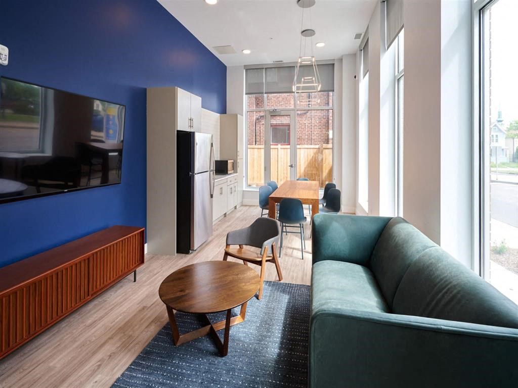 a living room filled with furniture and a large window