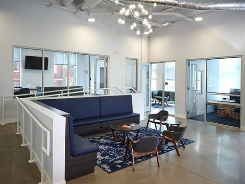 a living room with a blue couch and chairs