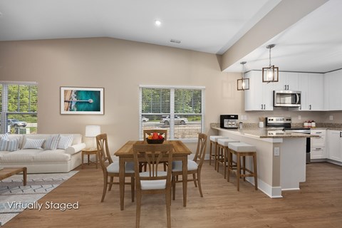 A kitchen with a table and chairs in the middle of the room.