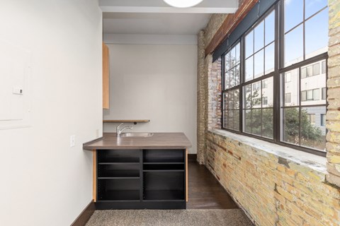 A kitchen with a sink and a window.