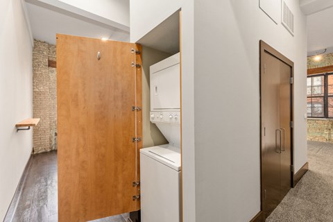 A kitchen with a wooden door and a white oven.