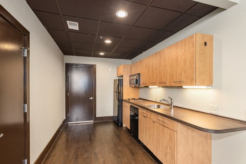 A kitchen with a sink, stove, and refrigerator.