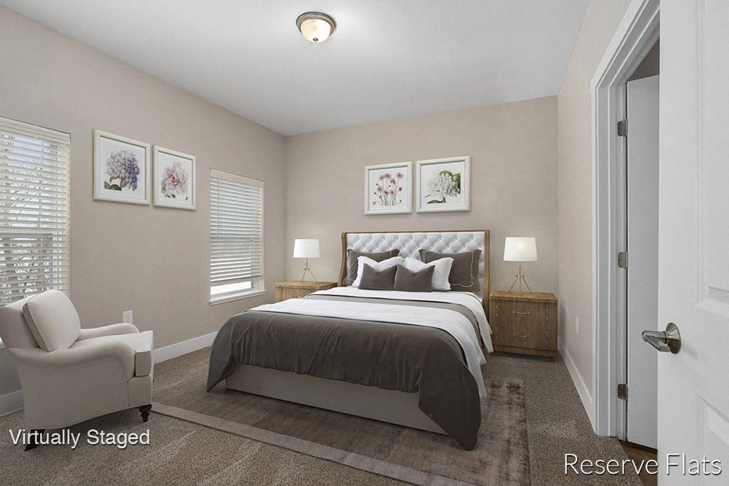 a bedroom with a bed and a chair and a door