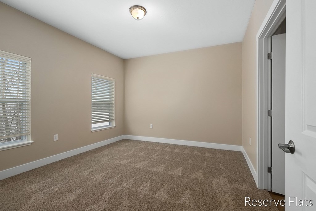 a empty room with a door and a window