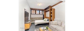 A living room with a white couch and a television.