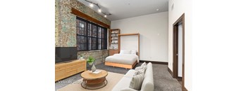 A living room with a brick wall and a television.