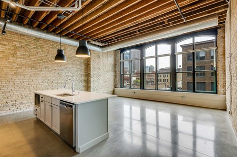 a kitchen with a large window and an island in the middle