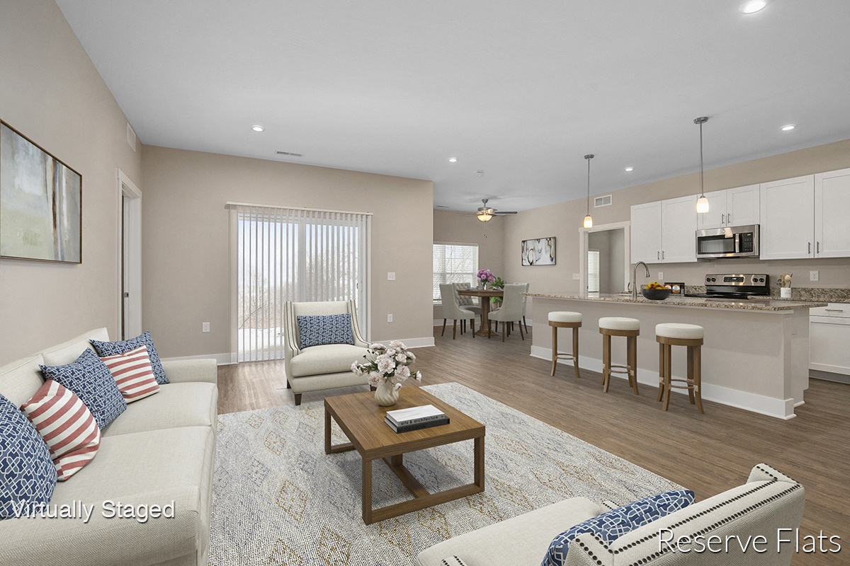 a living room and kitchen with a couch and a table