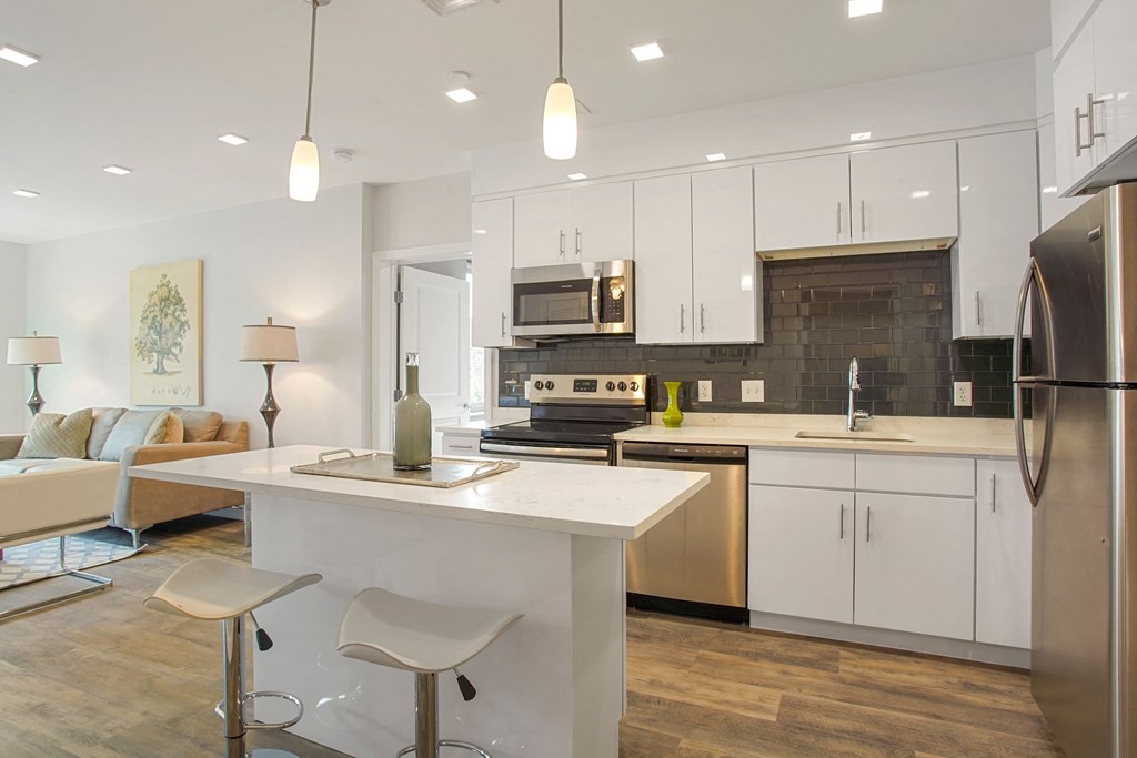 a kitchen with white cabinets and a white counter top