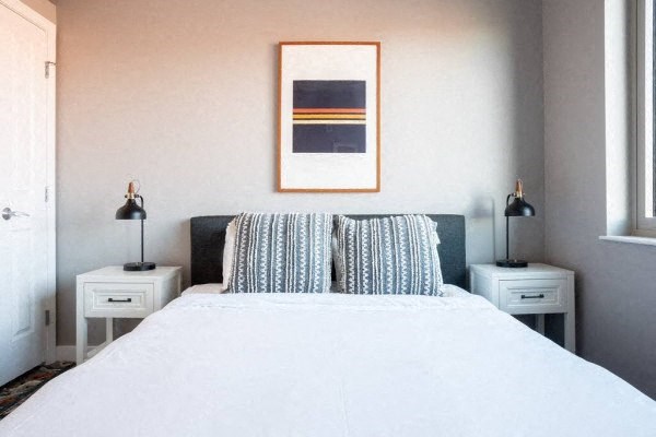 a bedroom with a bed and two night stands