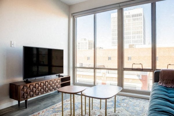 a living room with a large window and a flat screen tv