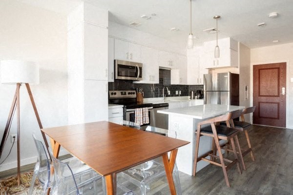 a kitchen with a wooden table and chairs