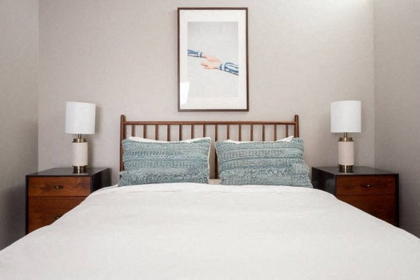 a bedroom with a bed and two night stands