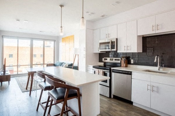 a kitchen with a white counter top and a stove top oven