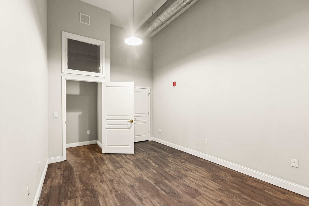 a living room with white walls and wood floors