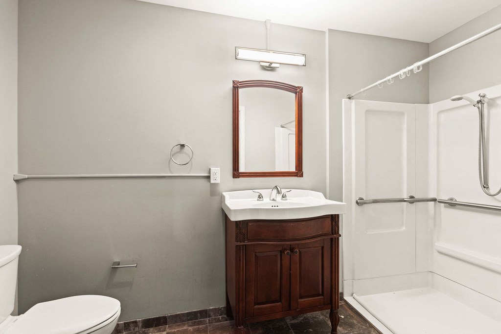 a bathroom with a sink toilet and shower