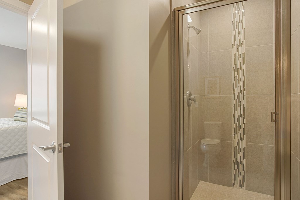 a bathroom with a shower and a bed