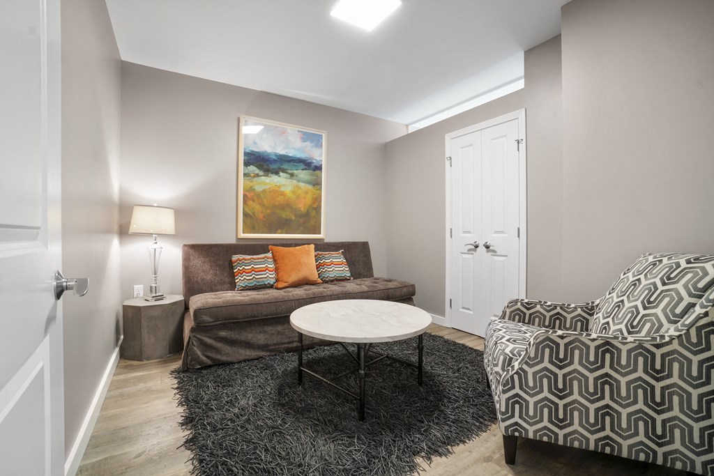 a living room with a couch chair and coffee table