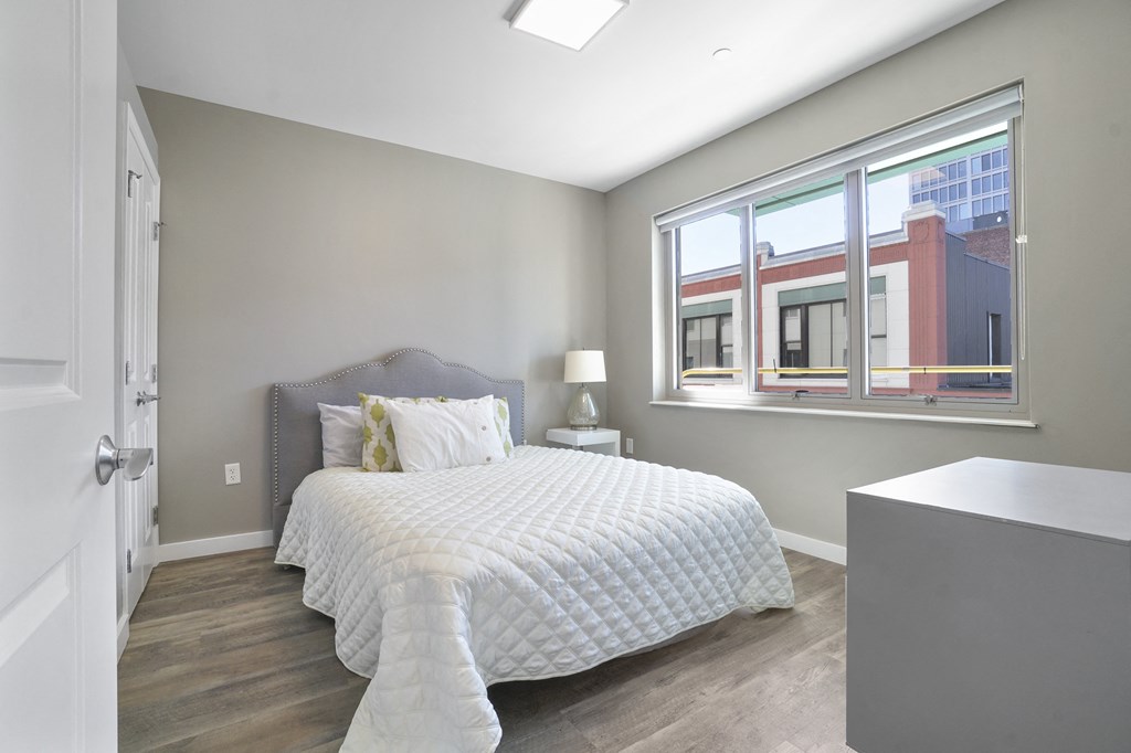 a bedroom with a large bed and a large window