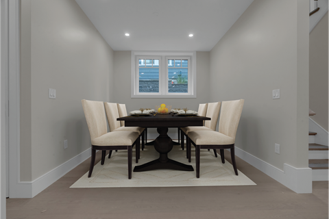a dining room with a table and chairs