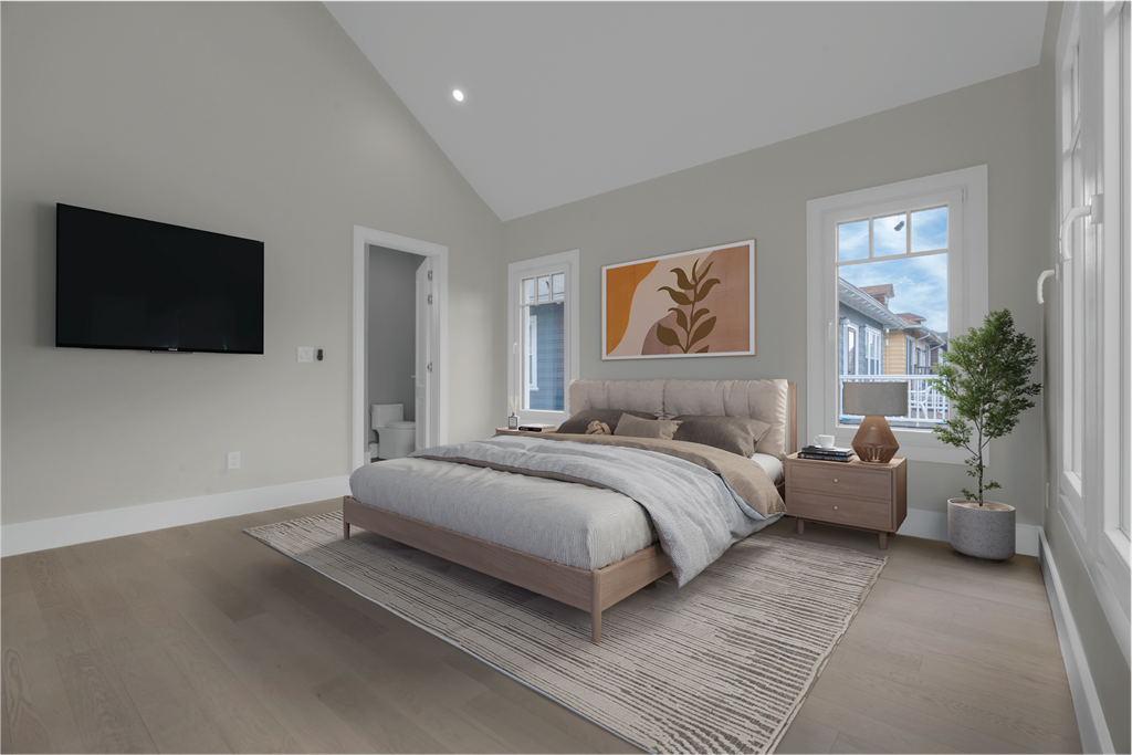 a bedroom with a bed and a tv on the wall