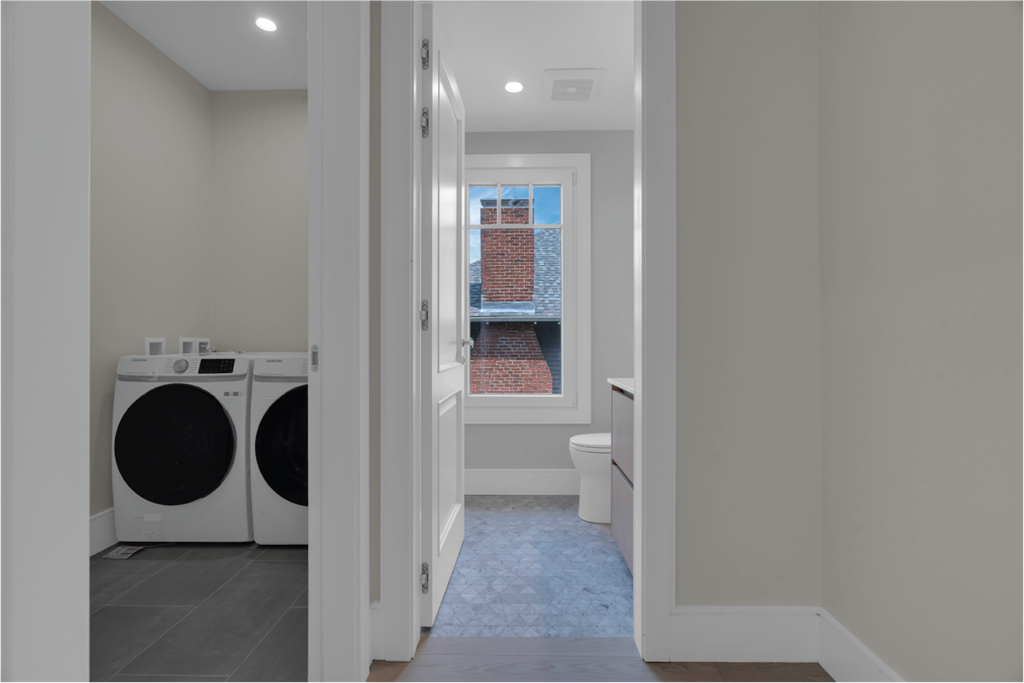 a laundry room with a washer and dryer and a window