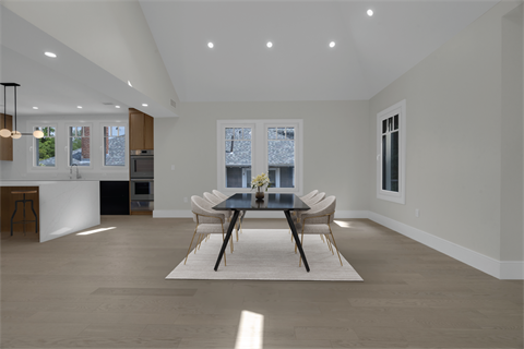 a dining room with a table and chairs and a kitchen