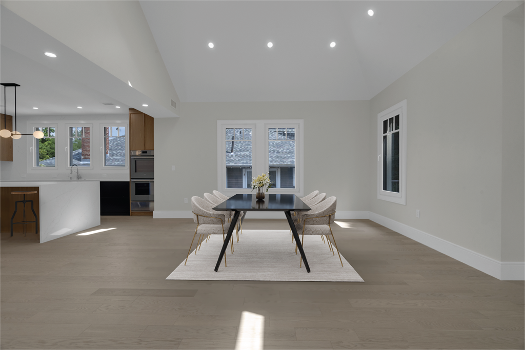 a dining room with a table and chairs and a kitchen