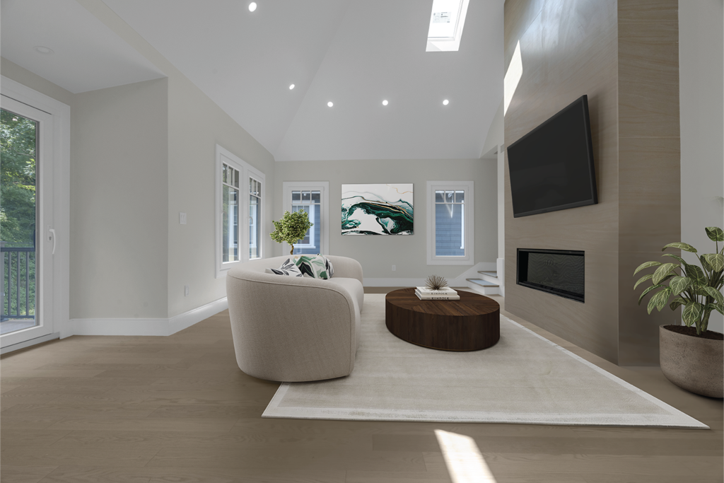 a living room with a white rug and a couch and a tv