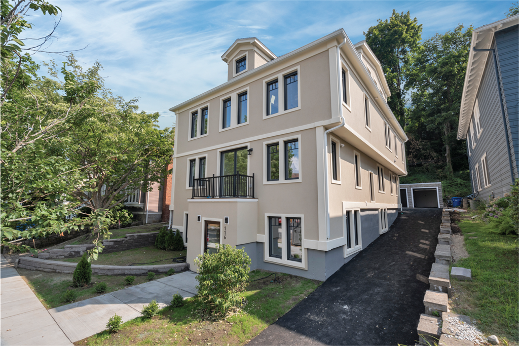 the front of a house with a yard and a sidewalk