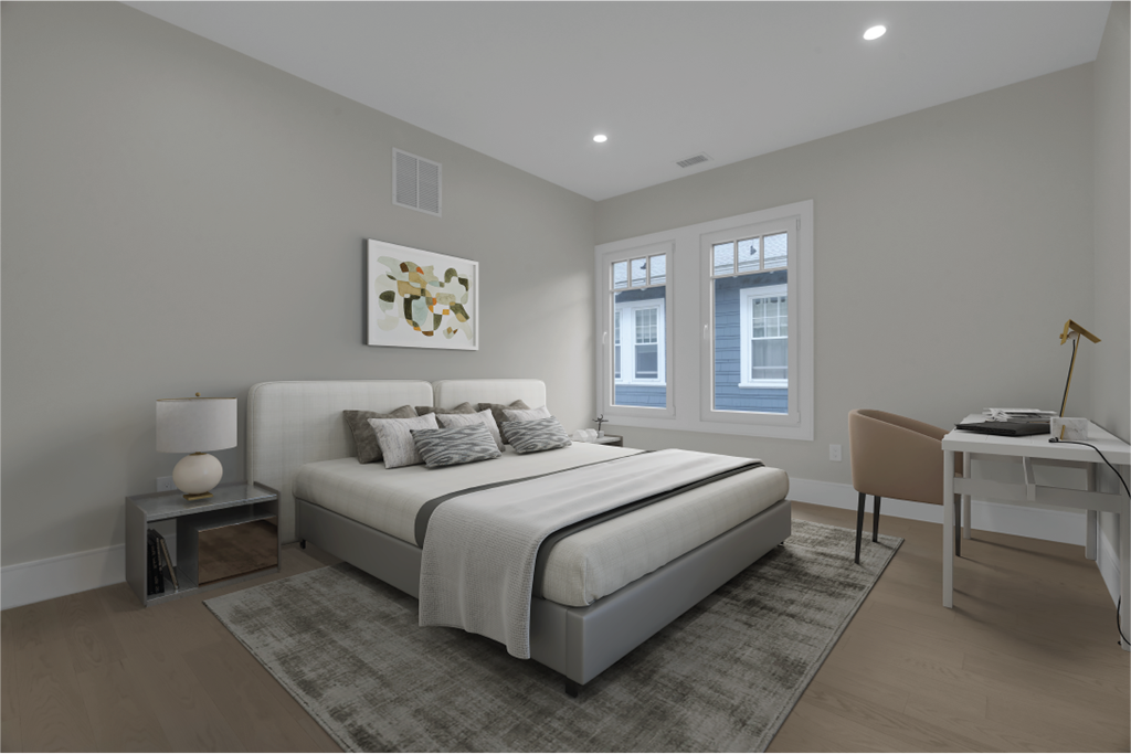 a bedroom with a bed and a desk with a chair