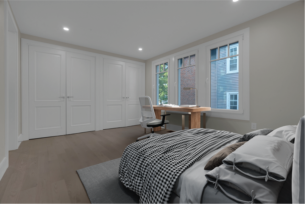 a bedroom with a bed and a desk with a chair