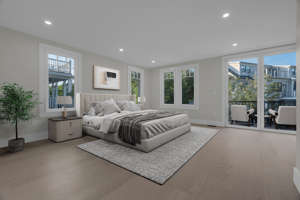 a large white bedroom with a bed and a rug