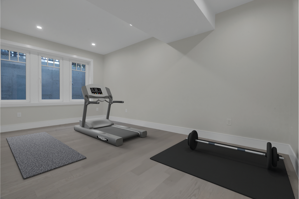 a gym with a reformer and yoga mats in a room with white walls