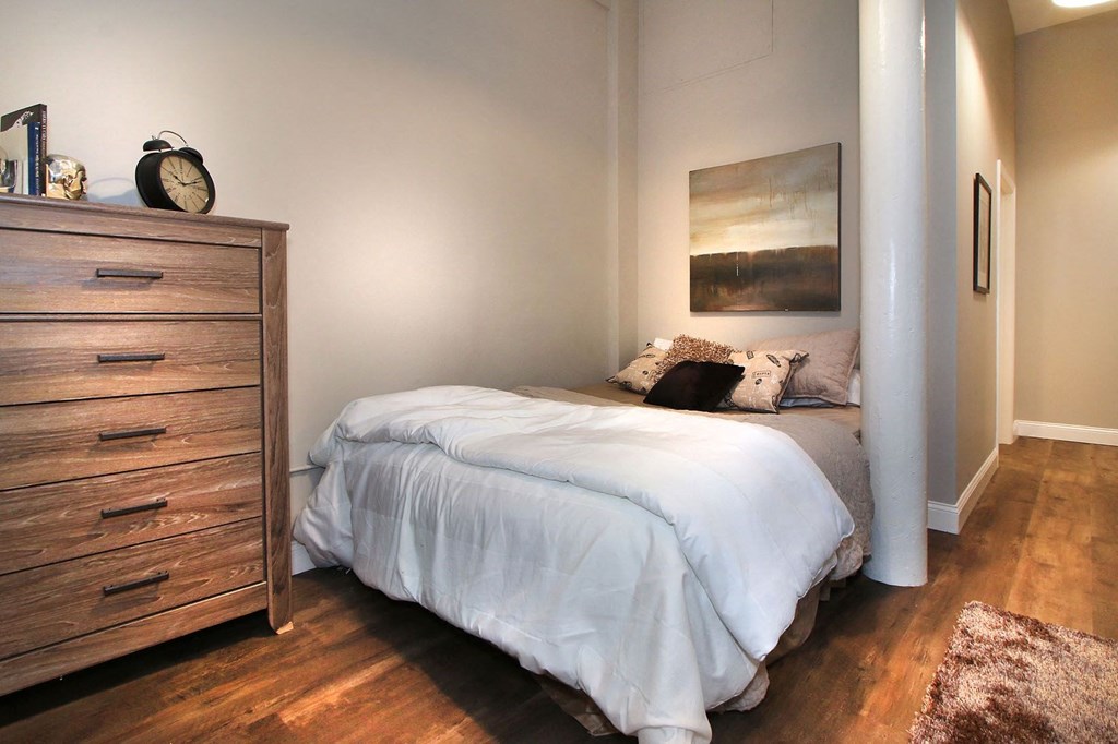 a bedroom with a bed and a dresser