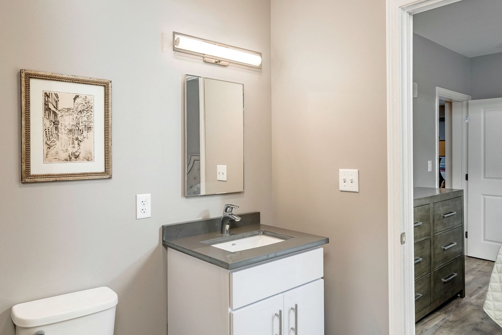 an empty bathroom with a sink and a mirror