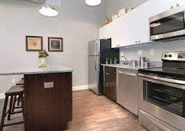 a kitchen with stainless steel appliances and a counter top