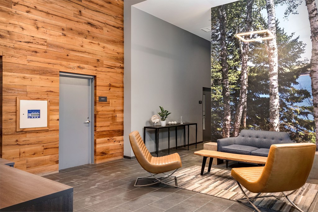 a living room with a couch and chairs and a table