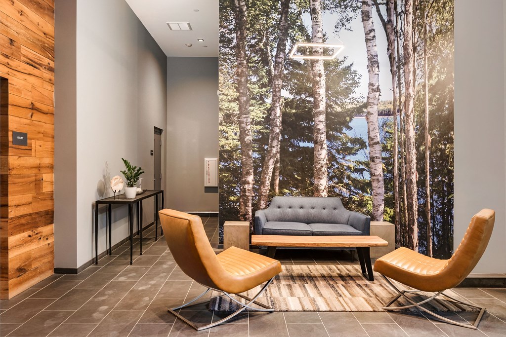 the living room of a condo with a couch and chairs