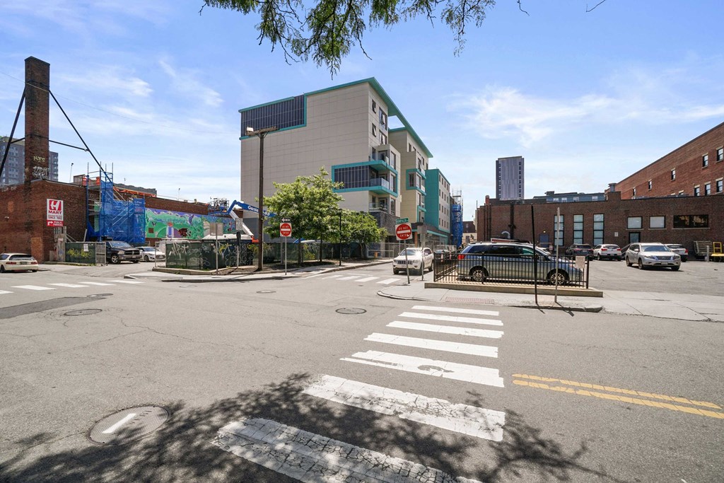 the corner of a city street with a building in the background