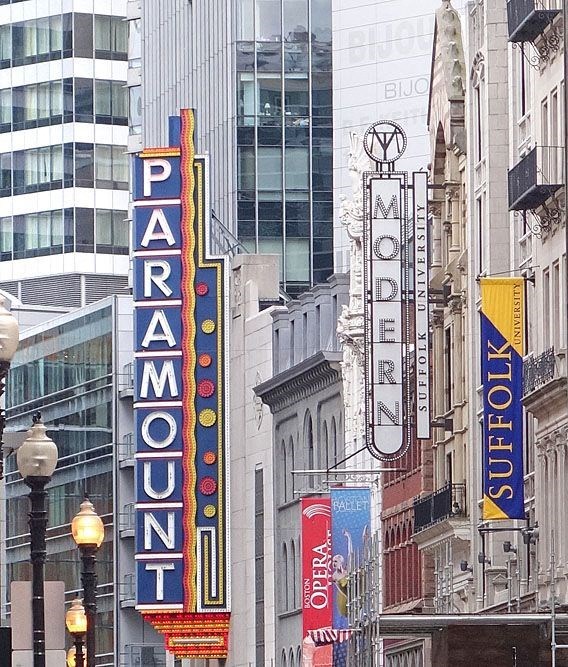 a city street with tall buildings and signs