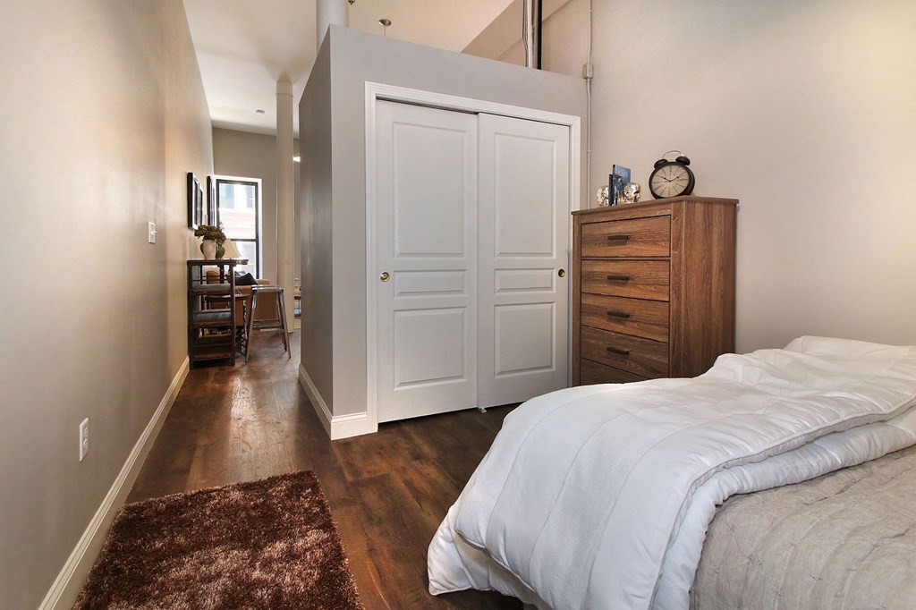 a bedroom with a bed and a closet